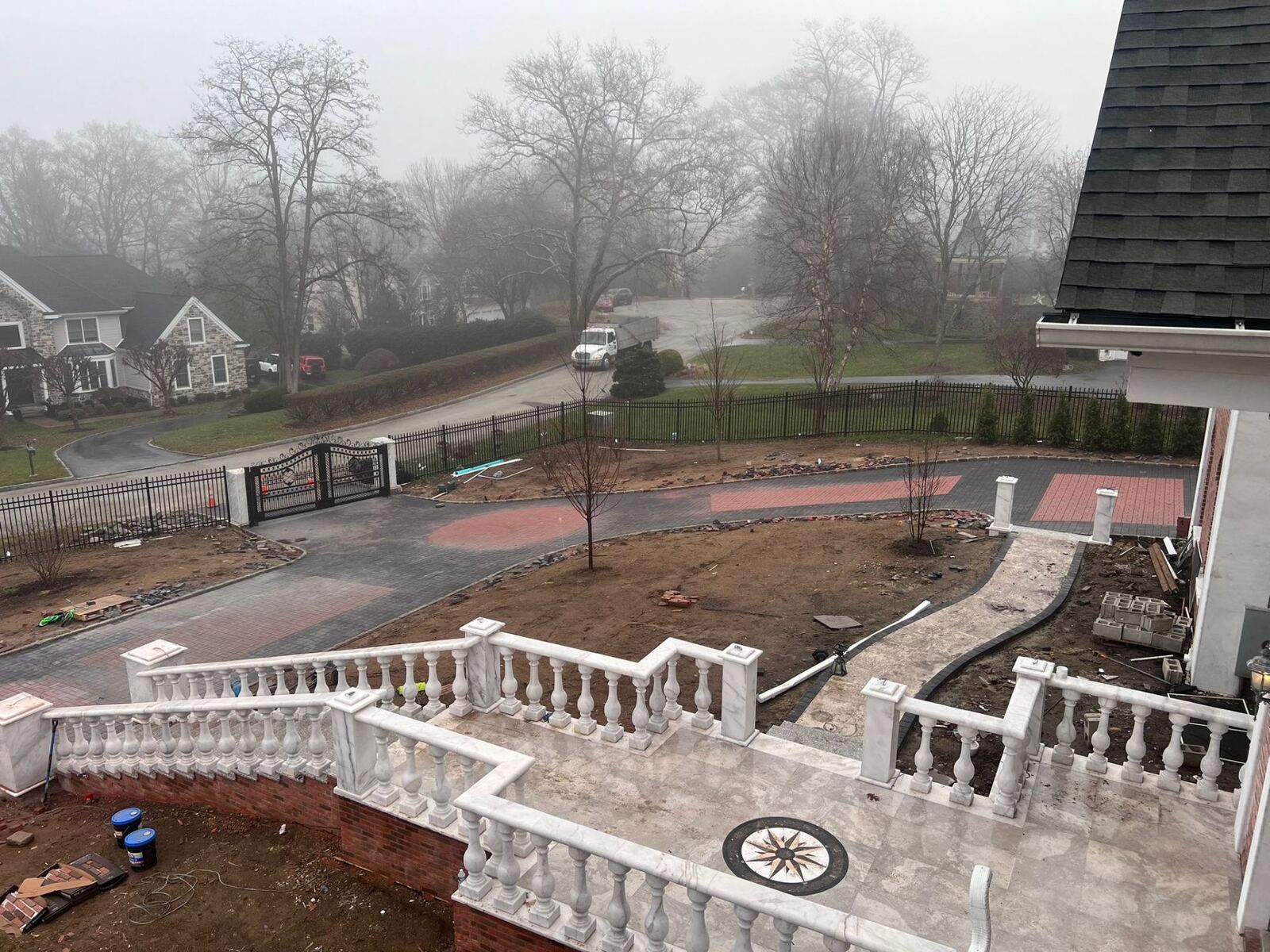 Luxury estate paver driveway with custom red brick inlay and marble balustrade installed by Affinity Contractors in Bucks County PA