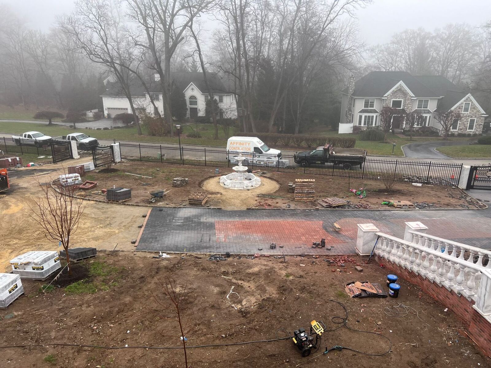 Custom paver driveway with center fountain courtyard installation by Affinity Contractors at a luxury Bucks County home