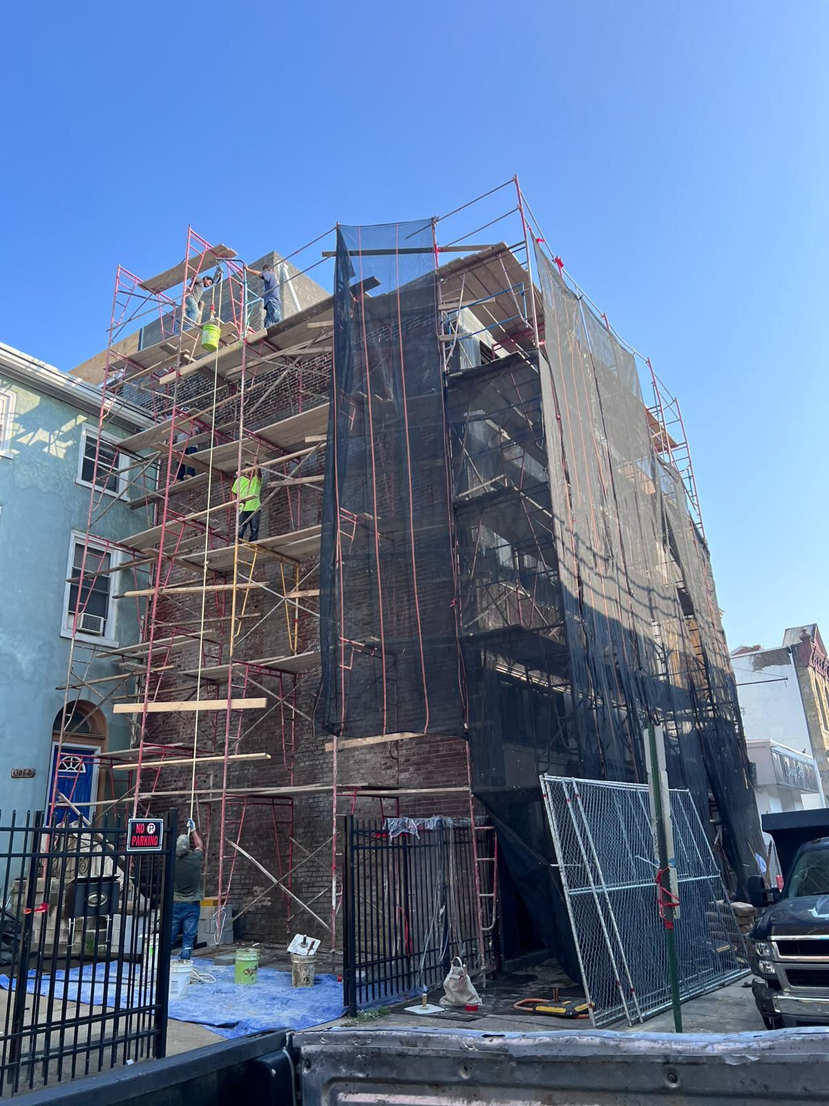 Scaffolded multi-story brick building facade restoration project in Philadelphia by Affinity Contractors crew